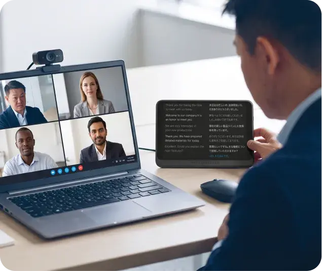 Pocketalk Z placed next to a laptop during an online meeting